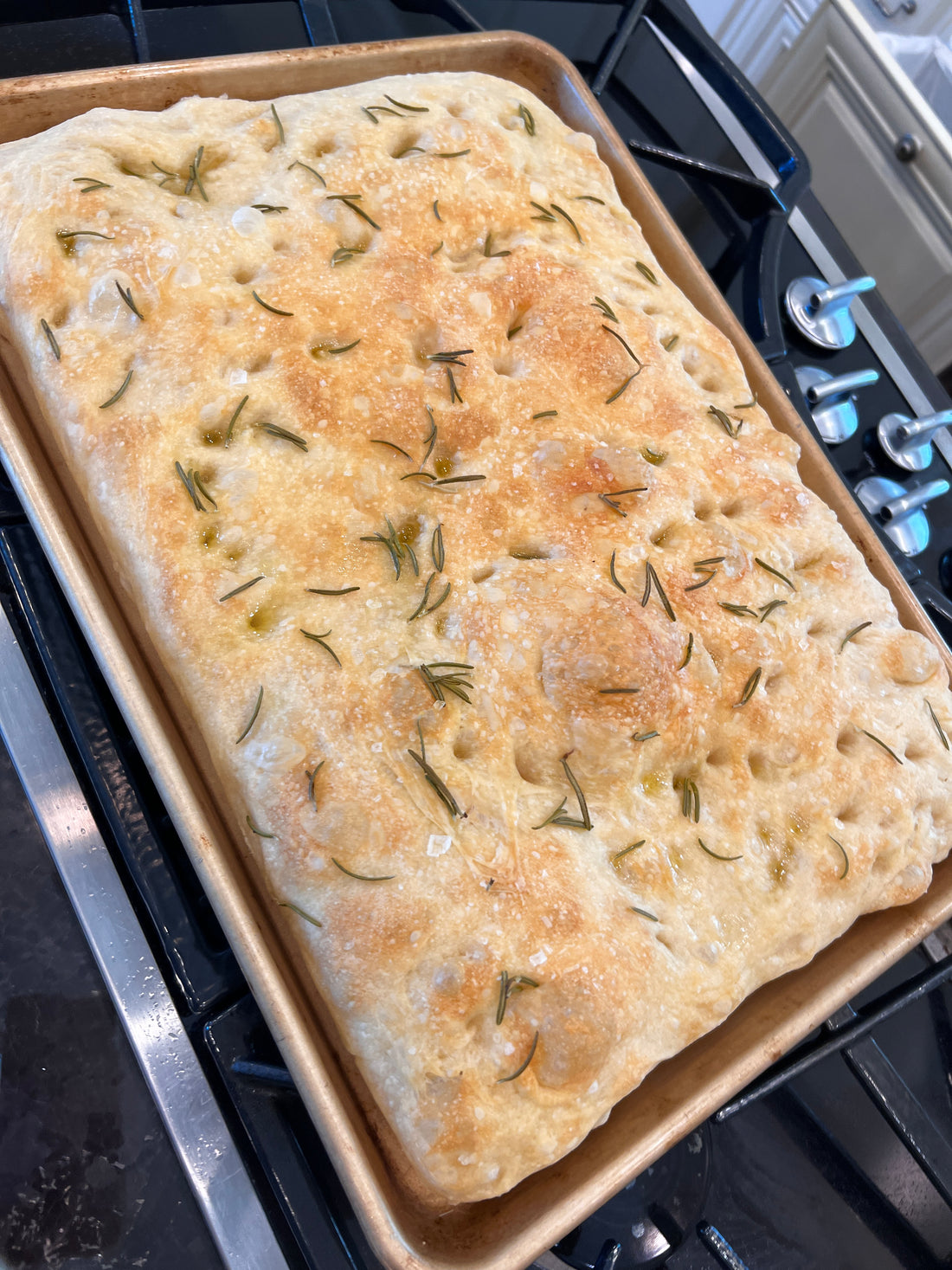Focaccia Bread sprinkled in Rosemary and flakey sea salt and covered in Il Bel Cuore Olive Oil